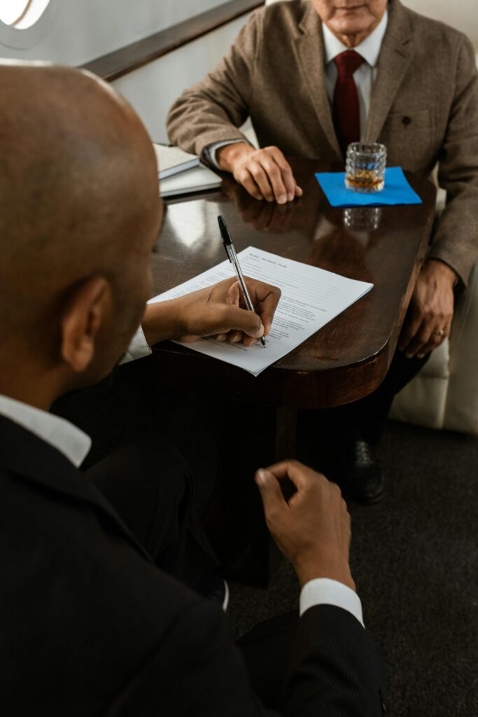 pexels-photo-5778658-5778658 Two businessmen in a serious meeting while signing an important document on a private jet.